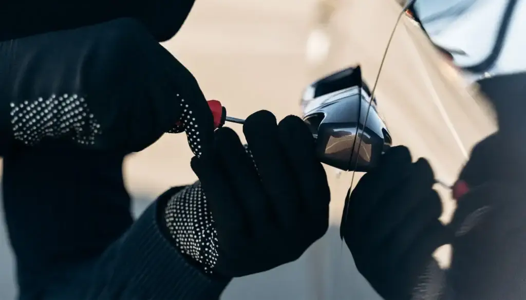 A criminal picking a lock to try hijack a car in South Africa