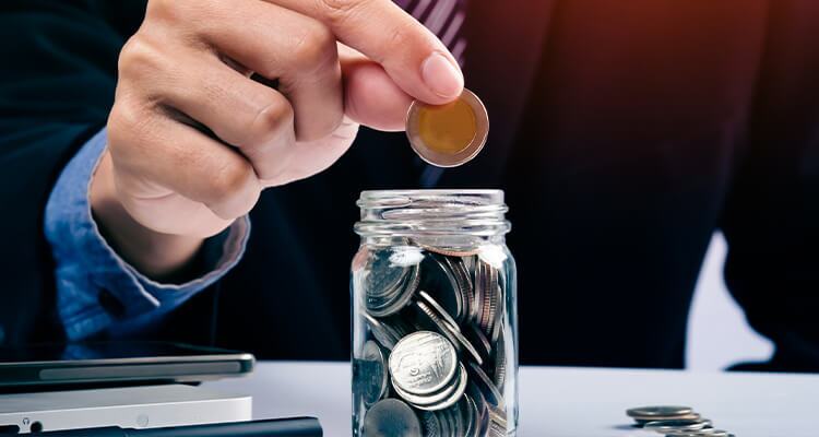 Coins are added to a jar of money to buy car insurance