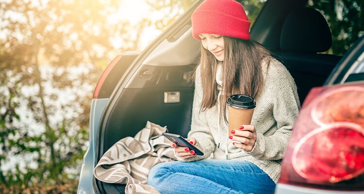 A person sitting in the open boot of your vehicle featuring car safety features