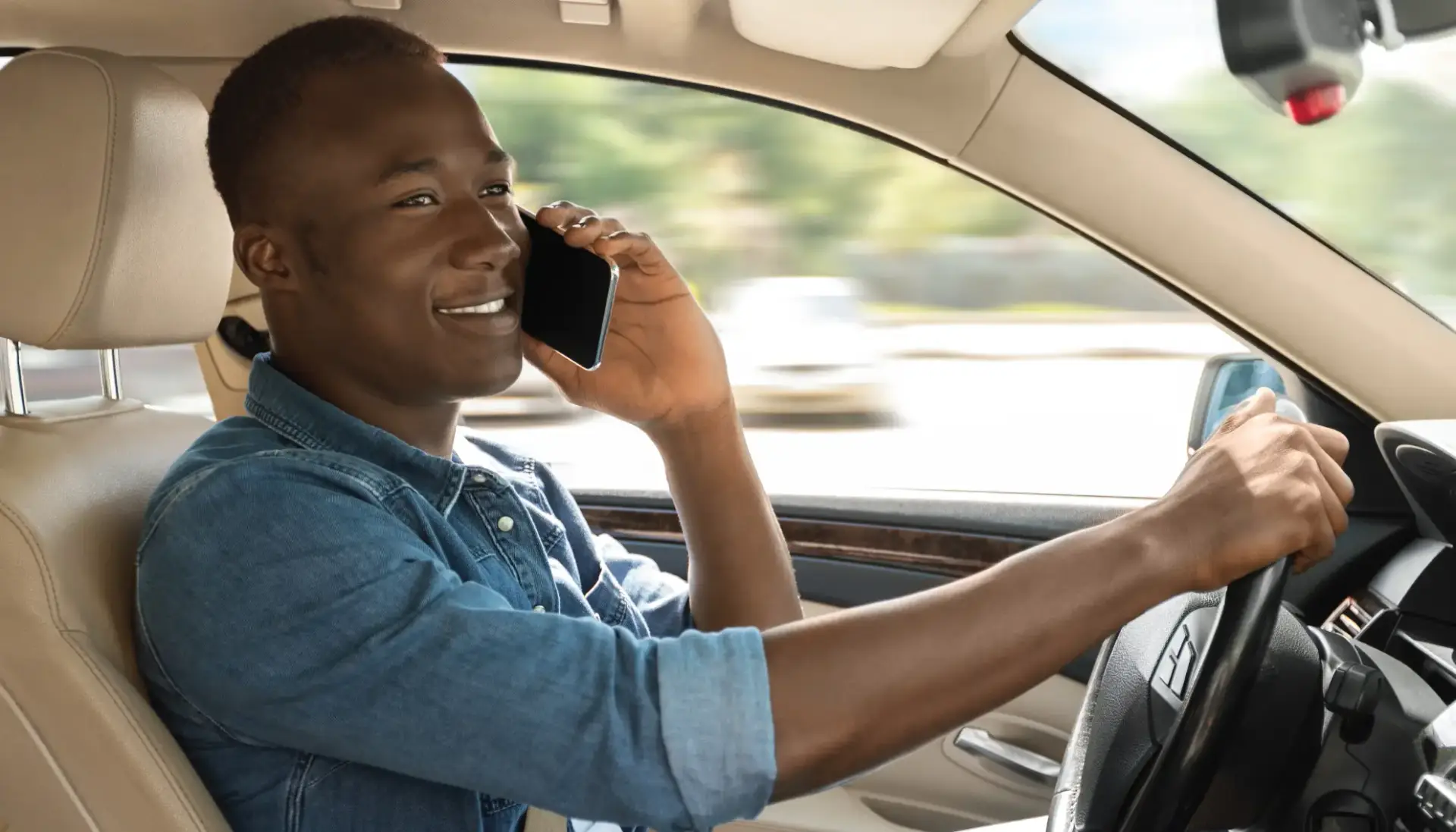 A man who hasn't adopted a habit of distraction-free driving is driving while talking on his phone.